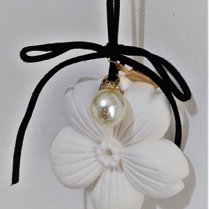 Ceramic daisy with pearl and fragrance bottle
